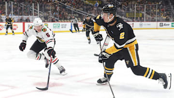 Apr 8, 2025; Pittsburgh, Pennsylvania, USA;  Pittsburgh Penguins right wing Rutger McGroarty (2) shoots the puck as Chicago Blackhawks defenseman Connor Murphy (5) defends during the first period at PPG Paints Arena. Mandatory Credit: Charles LeClaire-Imagn Images