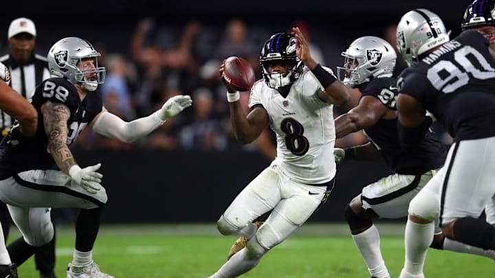 Sep 13, 2021; Paradise, Nevada, USA; Baltimore Ravens quarterback Lamar Jackson (8) runs the ball against Las Vegas Raiders defensive end Maxx Crosby (98) defensive end Yannick Ngakoue (91) and defensive tackle Johnathan Hankins (90) during the second half at Allegiant Stadium. Mandatory Credit: Mark J. Rebilas-Imagn Images