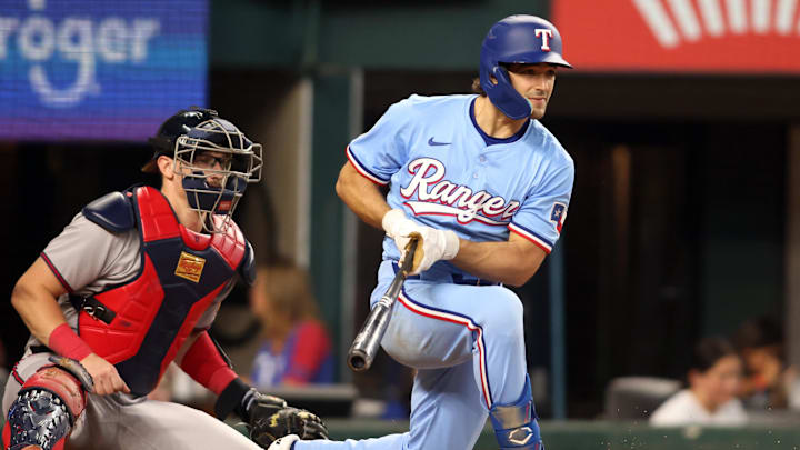 Jul 27, 2025; Arlington, Texas, USA; Texas Rangers first baseman Josh Smith (8) hits a single in the sixth inning against the Atlanta Braves at Globe Life Field.