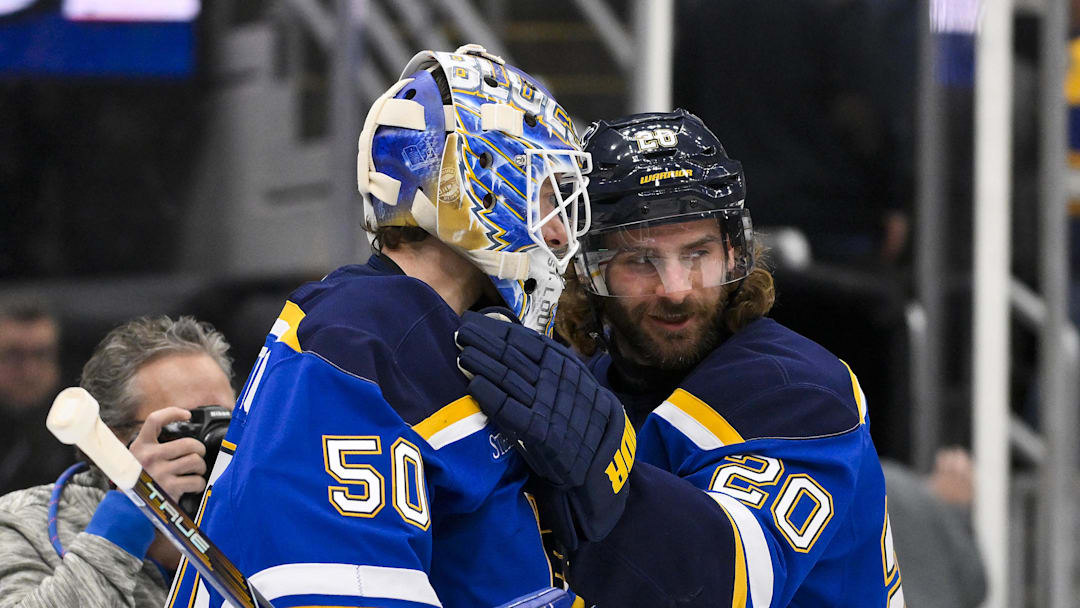 Jan 3, 2025; St. Louis, Missouri, USA;  St. Louis Blues left wing Brandon Saad (20) and goaltender Jordan Binnington (50) celebrate after the Blues defeated the Ottawa Senators at Enterprise Center. Mandatory Credit: Jeff Curry-Imagn Images