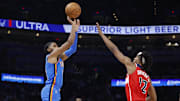 Oct 30, 2025; Oklahoma City, Oklahoma, USA; Oklahoma City Thunder guard Isaiah Joe (11) shoots a three point basket over Washington Wizards guard Tre Johnson (12) during the second half at Paycom Center. Mandatory Credit: Alonzo Adams-Imagn Images