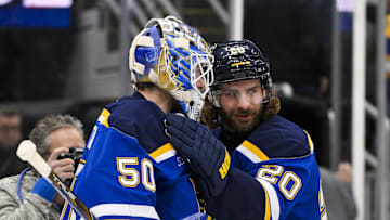 Jan 3, 2025; St. Louis, Missouri, USA;  St. Louis Blues left wing Brandon Saad (20) and goaltender Jordan Binnington (50) celebrate after the Blues defeated the Ottawa Senators at Enterprise Center. Mandatory Credit: Jeff Curry-Imagn Images