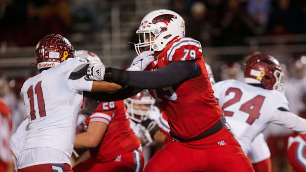 Nixa Eagles Jackson Cantwell holds back a Joplin defender during the championship game of Class 6 District 5 football at Nixa