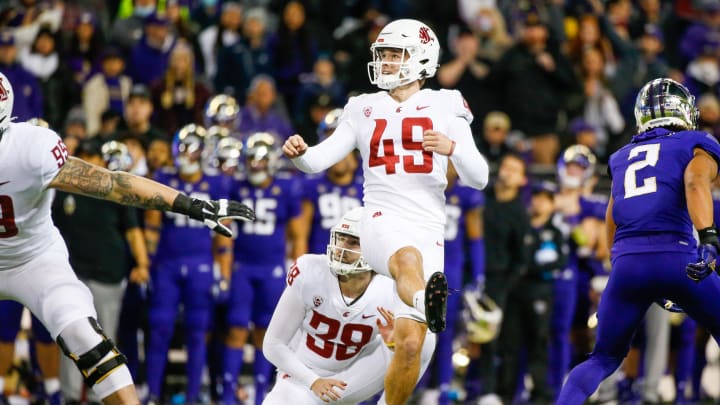 Nov 26, 2021; Seattle, Washington, USA; Washington State Cougars place kicker Dean Janikowski (49) attempts a field goal against the Washington Huskies during the second quarter at Alaska Airlines Field at Husky Stadium. Mandatory Credit: Joe Nicholson-USA TODAY Sports