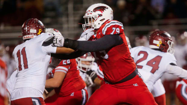 Nixa Eagles Jackson Cantwell holds back a Joplin defender during the championship game of Class 6 District 5 football at Nixa