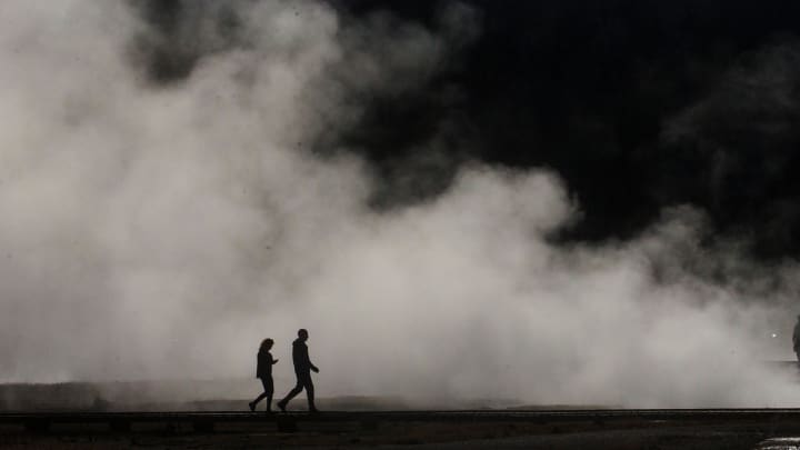 Visitors to Biscuit Basin loop at Yellowstone National Park tour the thermal features on June 25, 2021.