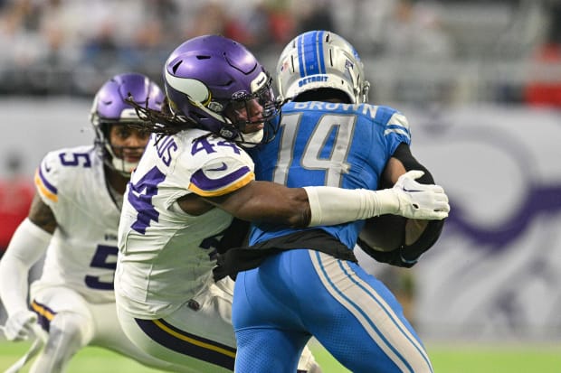 Dec 24, 2023; Minneapolis, Minnesota, USA; Detroit Lions wide receiver Amon-Ra St. Brown (14) is tackled by Minnesota Vikings safety Josh Metellus (44) during the game at U.S. Bank Stadium. Mandatory Credit: Jeffrey Becker-USA TODAY Sports