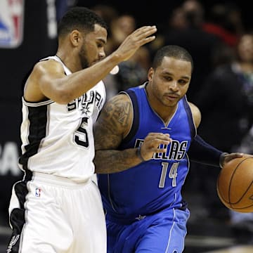 Jameer Nelson drives on the Spurs' Cory Joseph in 2014.