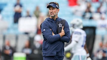 Oct 12, 2025; Charlotte, North Carolina, USA; Dallas Cowboys head coach Brian Schottenheimer looks on during warm ups prior the game against the Carolina Panthers at Bank of America Stadium. Mandatory Credit: Cory Knowlton-Imagn Images