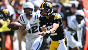 Sep 2, 2023; Iowa City, Iowa, USA; Iowa Hawkeyes quarterback Cade McNamara (12) tosses the ball during the third quarter against the Utah State Aggies at Kinnick Stadium. Mandatory Credit: Jeffrey Becker-USA TODAY Sports