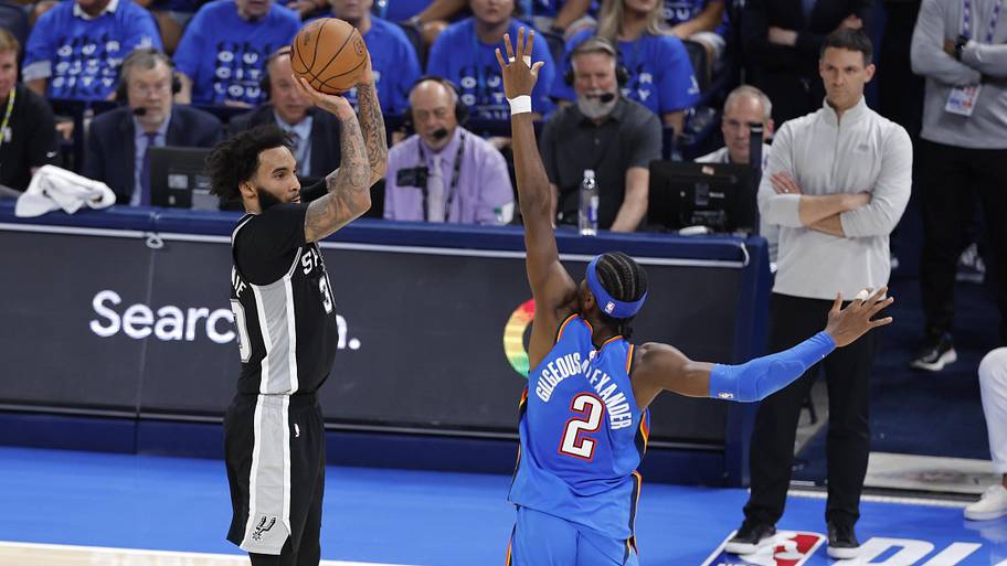 Spurs forward Julian Champagnie shoots against Thunder guard Shai Gilgeous-Alexander.