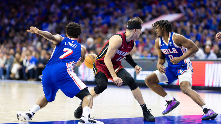 Apr 17, 2024; Philadelphia, Pennsylvania, USA; Philadelphia 76ers guard Kyle Lowry (7) and guard Tyrese Maxey (0) take the ball away from Miami Heat guard Tyler Herro (14) during the first quarter of a play-in game of the 2024 NBA playoffs at Wells Fargo Center. Mandatory Credit: Bill Streicher-USA TODAY Sports