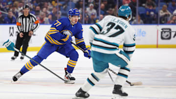Mar 4, 2025; Buffalo, New York, USA;  Buffalo Sabres right wing JJ Peterka (77) looks to make a pass as San Jose Sharks defenseman Timothy Liljegren (37) defends during the second period at KeyBank Center. Mandatory Credit: Timothy T. Ludwig-Imagn Images