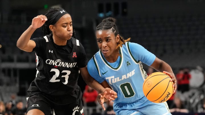 Mar 6, 2023; Fort Worth, TX, USA;  Tulane Green Wave guard Kyren Whittington (0) drives to the basket against Cincinnati Bearcats guard Mya Jackson (23) during the second half at Dickies Arena. 