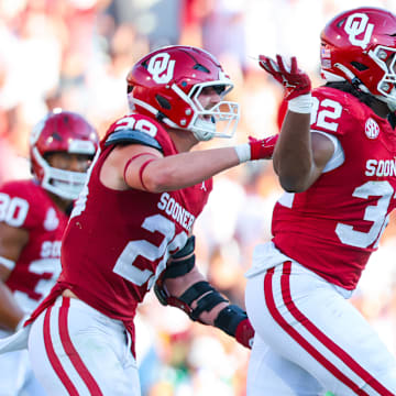 Sep 14, 2024; Norman, Oklahoma, USA; Oklahoma Sooners defensive lineman R Mason Thomas (32) celebrates with Oklahoma Sooners linebacker Danny Stutsman (28) during the second half against the Tulane Green Wave at Gaylord Family-Oklahoma Memorial Stadium. 