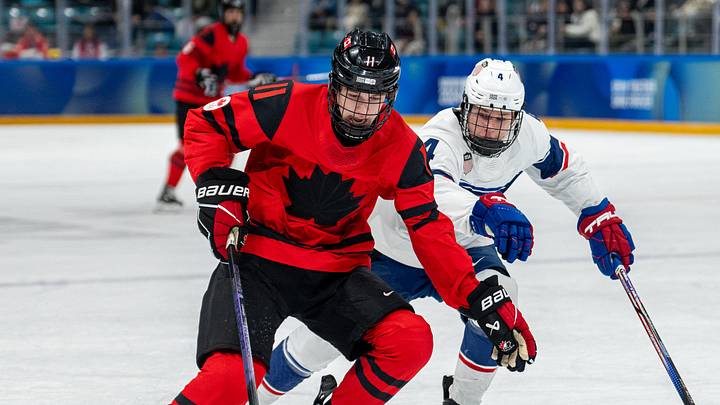 Jan 30, 2024; Gangwon-do, KOR; Tynan Lawrence (CAN) skates with the puck while under pressure from AJ Francisco (USA) in the Ice Hockey Men s 6-on-6 Tournament Semifinals between Canada and (USA) at the Gangneung Hockey Centre. The Winter Youth Olympic Games, Gangwon, South Korea, Tuesday 30 January 2024. Mandatory Credit: OIS/Thomas Lovelock-Imagn Images