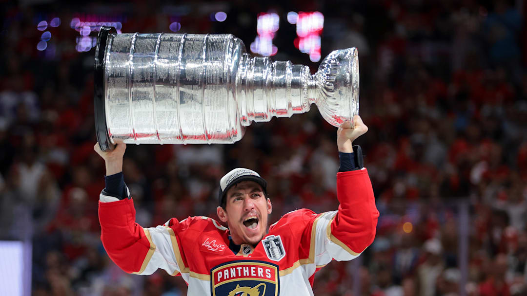 Jun 17, 2025; Sunrise, Florida, USA; Florida Panthers left wing Tomas Nosek (92) hoists the Stanley Cup after winning game six of the 2025 Stanley Cup Final against the Edmonton Oilers at Amerant Bank Arena. 