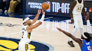 Oct 23, 2025; Indianapolis, Indiana, USA;  Indiana Pacers guard Andrew Nembhard (2) shoots the ball while Oklahoma City Thunder guard Luguentz Dort (5) defends in the first half at Gainbridge Fieldhouse. Mandatory Credit: Trevor Ruszkowski-Imagn Images
