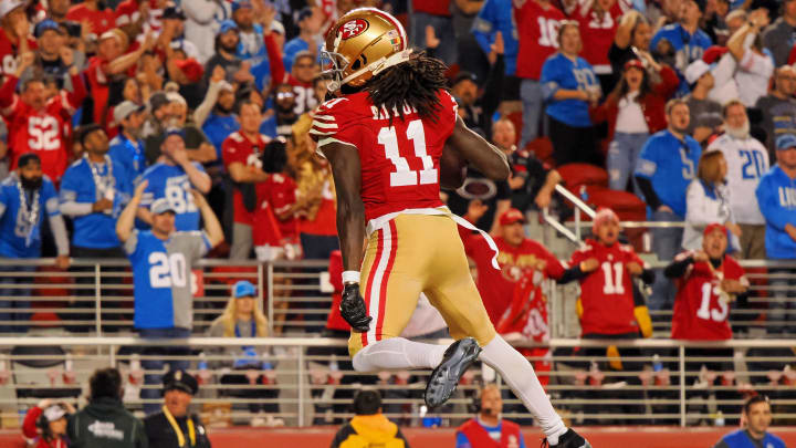 Jan 28, 2024; Santa Clara, California, USA; San Francisco 49ers wide receiver Brandon Aiyuk (11) reacts after catching a ball that bounced off the face mask of Detroit Lions cornerback Kindle Vildor (not pictured) during the second half of the NFC Championship football game at Levi's Stadium. Mandatory Credit: Kelley L Cox-USA TODAY Sports