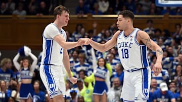 Mar 3, 2025; Durham, North Carolina, USA; Duke Blue Devils forward Mason Gillis (18) is greeted by teammate Cooper Flagg (2) after hitting a three-point shot during the second half against the Wake Forest Demon Deacons at Cameron Indoor Stadium.  The Blue Devils won 93-60. Mandatory Credit: Rob Kinnan-Imagn Images