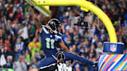 Oct 20, 2025; Seattle, Washington, USA; Seattle Seahawks wide receiver Jaxon Smith-Njigba (11) celebrates on the goal post after a touchdown during the first quarter against the Houston Texans at Lumen Field.