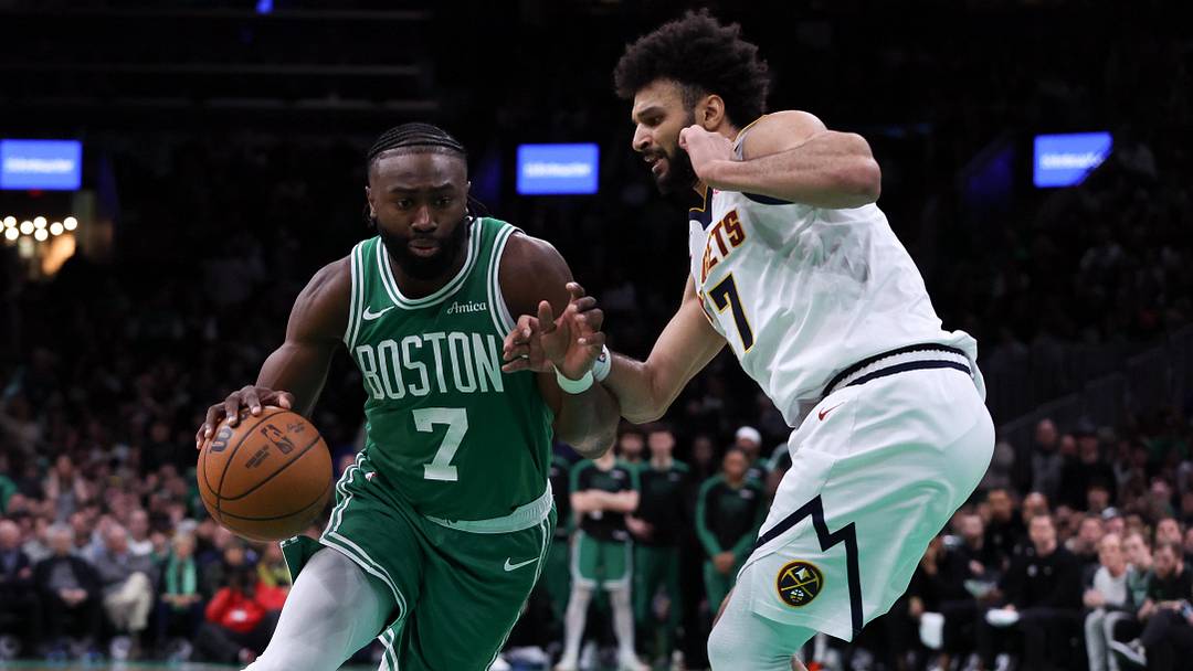 Mar 2, 2025; Boston, Massachusetts, USA; Boston Celtics forward Jaylen Brown (7) drives to the basket defended by Denver Nuggets guard Jamal Murray (27) during the second half at TD Garden. Mandatory Credit: Paul Rutherford-Imagn Images