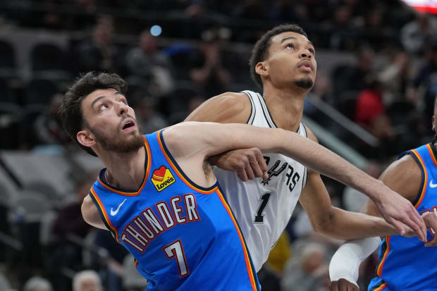 Oklahoma City Thunder forward Chet Holmgren (7) and San Antonio Spurs center Victor Wembanyama (1) battle for position.