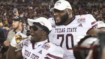 Dec 26, 2023; Dallas, TX, USA; Texas State Bobcats running back Ismail Mahdi (21) and offensive lineman Brey Walker (70) celebrate after the game against the Rice Owls at Gerald J Ford Stadium. Mandatory Credit: Tim Heitman-USA TODAY Sports