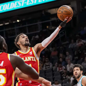 Apr 10, 2024; Atlanta, Georgia, USA; Atlanta Hawks guard Trae Young (11) goes to the basket against the Charlotte Hornets during the first half at State Farm Arena. Mandatory Credit: Dale Zanine-USA TODAY Sports