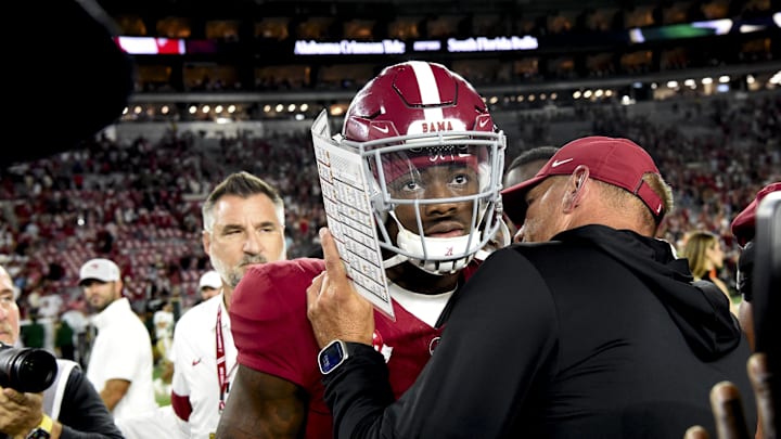 Sep 7, 2024; Tuscaloosa, Alabama, USA;  Alabama Crimson Tide head coach Kalen DeBoer gives some encouragement to quarterback Jalen Milroe (4) at Bryant-Denny Stadium after defeating the South Florida Bulls. Mandatory Credit: Gary Cosby Jr.-Imagn Images