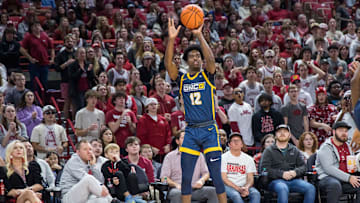 Dec 6, 2022; Fayetteville, Arkansas, USA;  UNC-Greensboro Spartans guard Donovan Atwell (12) shoots the ball during the first half against the Arkansas Razorbacks at Bud Walton Arena. Arkansas won 65-58. Mandatory Credit: Brett Rojo-Imagn Images