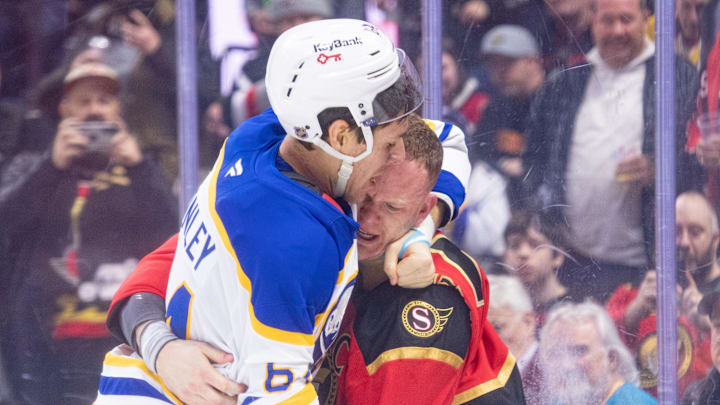 Apr 2, 2026; Ottawa, Ontario, CAN; Buffalo Sabres defenseman Logan Stanley (64) fights with Ottawa Senators left wing Brady Tkachuk (7) in the first period at the Canadian Tire Centre. Mandatory Credit: Marc DesRosiers-IMAGN Images