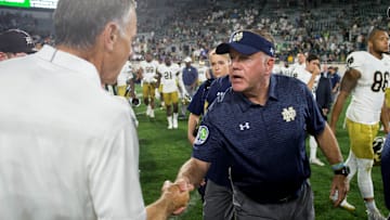 Sep 23, 2017; East Lansing, MI, USA; Notre Dame Fighting Irish head coach Brian Kelly and Michigan State Spartans head coach Mark Dantonio shake hands after Notre Dame defeated MSU at Spartan Stadium. Mandatory Credit: Matt Cashore-Imagn Images