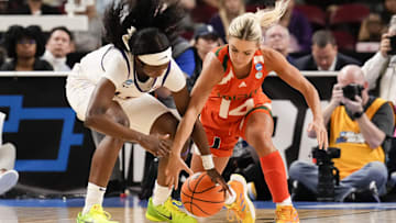 Mar 26, 2023; Greenville, SC, USA; LSU Lady Tigers guard Alexis Morris (45) and Miami Hurricanes guard Haley Cavinder (14) chase the loose ball during the second half in the NCAA Women   s Tournament at Bon Secours Wellness Arena. Mandatory Credit: Jim Dedmon-Imagn Images