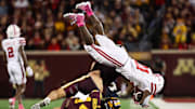 Oct 17, 2025; Minneapolis, Minnesota, USA; Minnesota Golden Gophers defensive back Kerry Brown (14) tackles Nebraska Cornhuskers running back Emmett Johnson (21) during the second half at Huntington Bank Stadium. 