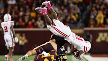 Oct 17, 2025; Minneapolis, Minnesota, USA; Minnesota Golden Gophers defensive back Kerry Brown (14) tackles Nebraska Cornhuskers running back Emmett Johnson (21) during the second half at Huntington Bank Stadium. 
