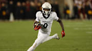 Nov 16, 2024; Ames, Iowa, USA; Cincinnati Bearcats wide receiver Tony Johnson (0) runs for a first down against the  Iowa State Cyclones in the second half at Jack Trice Stadium. The Iowa State Cyclones won the game 34-17.  Mandatory Credit: Reese Strickland-Imagn Images