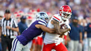 Sep 13, 2024; Manhattan, Kansas, USA; Arizona Wildcats wide receiver Tetairoa McMillan (4) is tackled by Kansas State Wildcats cornerback Keenan Garber (1) during the first quarter at Bill Snyder Family Football Stadium. Mandatory Credit: Scott Sewell-Imagn Images