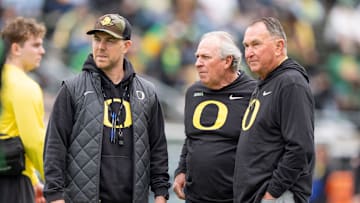 Oregon offensive coordinator Will Stein, left, former Oregon defensive coordinator Nick Aliotti and former Oregon coach Rich Brooks talk before the game as the Fighting Ducks face off against Mighty Oregon in the Oregon Ducks spring game on April 26, 2025, at Autzen Stadium in Eugene.