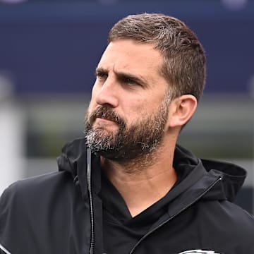 Philadelphia Eagles head coach Nick Sirianni watches the team warm up before a game against the New England Patriots at Gillette Stadium. 