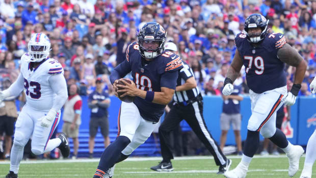 Chicago Bears quarterback Caleb Williams (18) runs with the ball against the Buffalo Bills during the first half of a game.