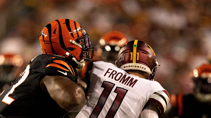 Cincinnati Bengals defensive tackle Domenique Davis (72) hits Washington Commanders quarterback Jake Fromm (11) in the fourth quarter of the NFL preseason week 3 game between the Cincinnati Bengals and the Washington Commanders at FedEx Field in Landover, M.D., on Saturday, Aug. 26, 2023.