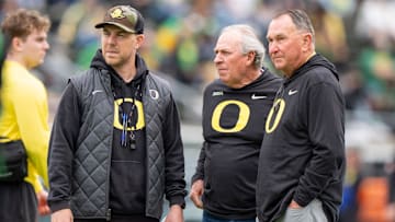 Oregon offensive coordinator Will Stein, left, former Oregon defensive coordinator Nick Aliotti and former Oregon coach Rich Brooks talk before the game as the Fighting Ducks face off against Mighty Oregon in the Oregon Ducks spring game on April 26, 2025, at Autzen Stadium in Eugene.