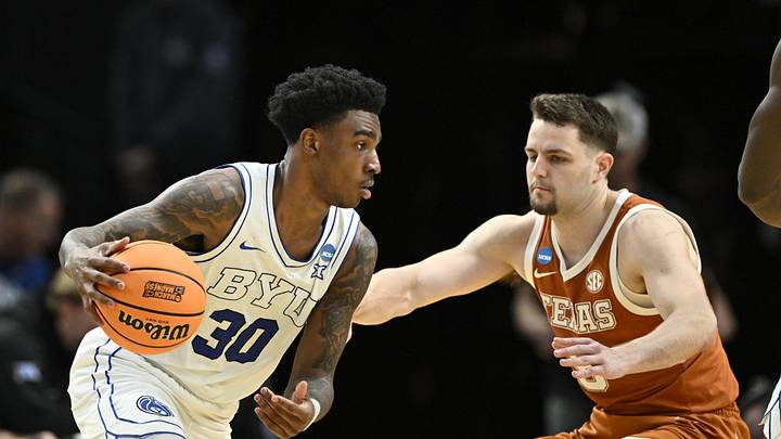 Mar 19, 2026; Portland, OR, USA; BYU Cougars guard Kennard Davis Jr. (30) dribbles against Texas Longhorns forward Camden Heide (5) in the second half during a first round game of the men's 2026 NCAA Tournament at Moda Center. Mandatory Credit: Craig Strobeck-Imagn Images