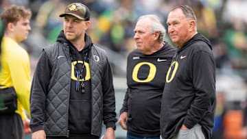 Oregon offensive coordinator Will Stein, left, former Oregon defensive coordinator Nick Aliotti and former Oregon coach Rich Brooks talk before the game as the Fighting Ducks face off against Mighty Oregon in the Oregon Ducks spring game on April 26, 2025, at Autzen Stadium in Eugene.