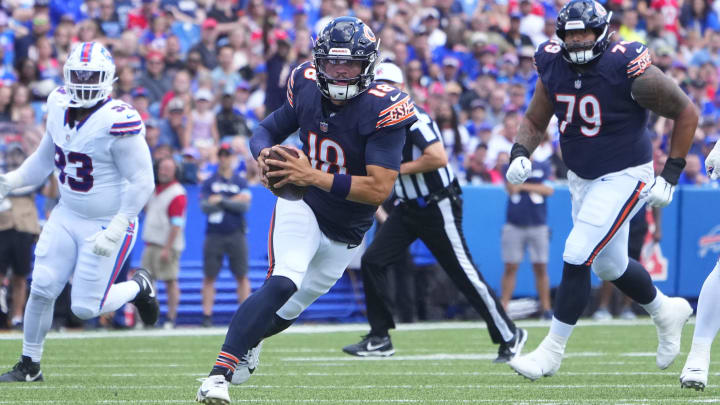 Caleb Williams escapes the pocket on a 13-yard scramble to convert third-and-9 against the Bills.