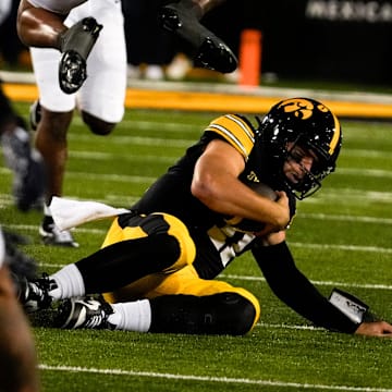 Iowa Hawkeyes quarterback Mark Gronowski (11) slides during a college football game against the Penn State Nittany Lions Oct. 18, 2025 at Kinnick Stadium in Iowa City, Iowa.