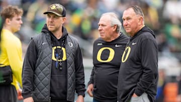 Oregon offensive coordinator Will Stein, left, former Oregon defensive coordinator Nick Aliotti and former Oregon coach Rich Brooks talk before the game as the Fighting Ducks face off against Mighty Oregon in the Oregon Ducks spring game on April 26, 2025, at Autzen Stadium in Eugene.