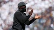 Oct 5, 2024; University Park, Pennsylvania, USA; UCLA Bruins head coach DeShaun Foster claps his hands from the sideline during the second quarter against the Penn State Nittany Lions at Beaver Stadium. Mandatory Credit: Matthew O'Haren-Imagn Images