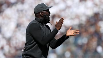 UCLA Bruins head coach DeShaun Foster claps his hands at the news. 
